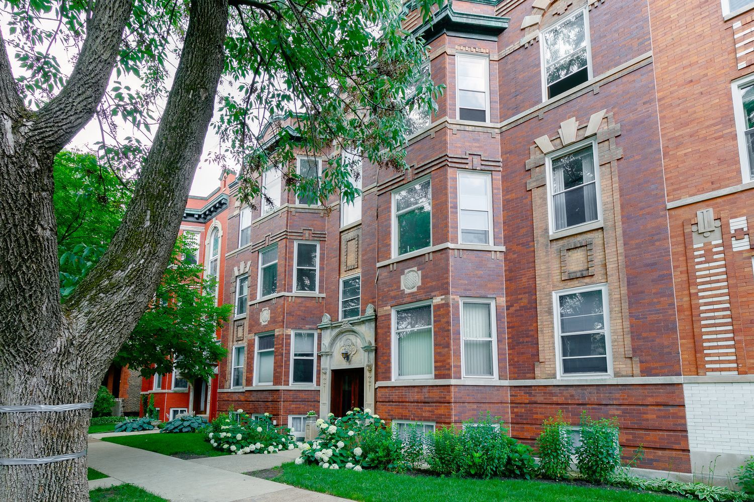 2137 West Cortez Street, Unit 2 Chicago, IL 60622 - Photo 2 of 19 a view of a brick building next to a yard
