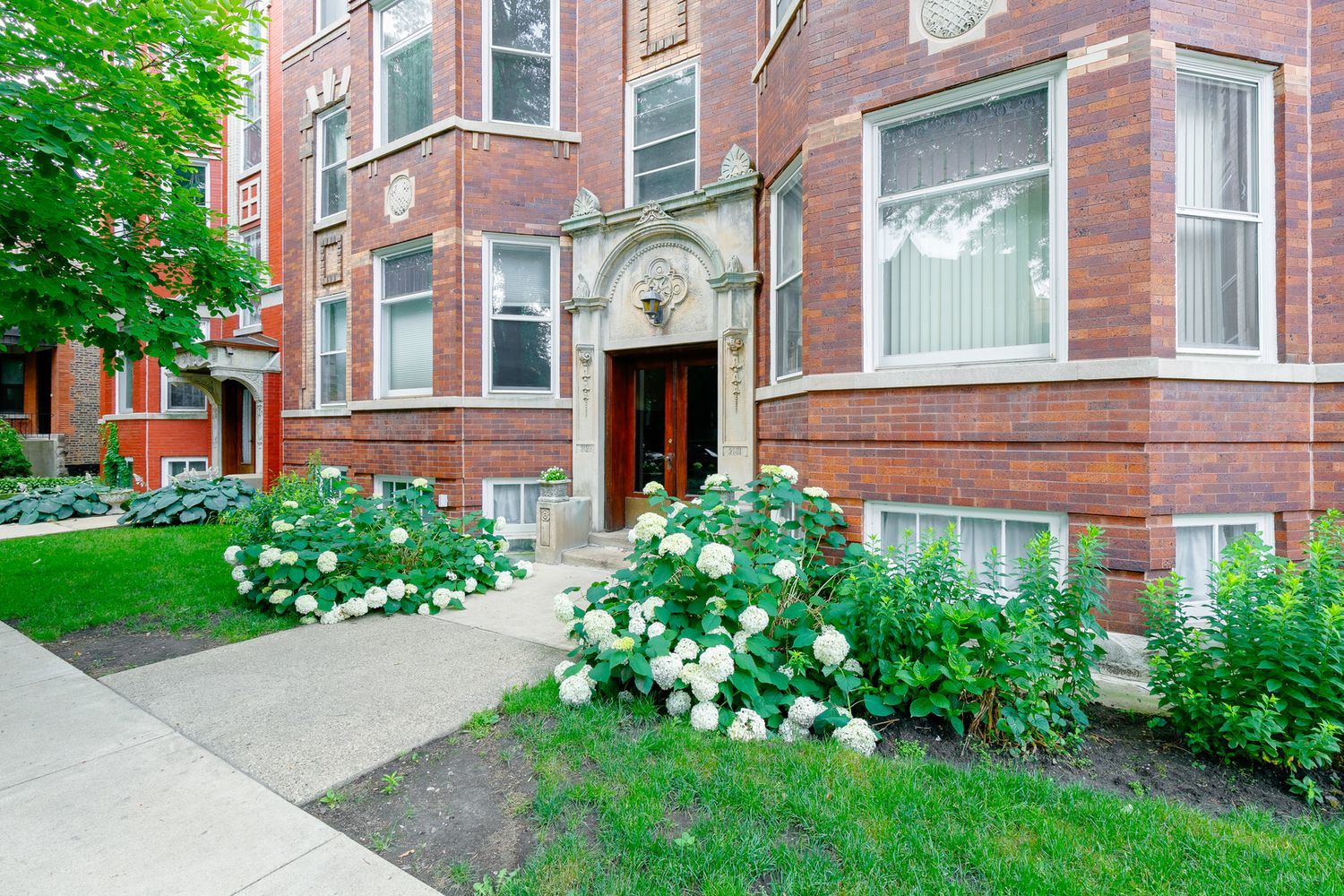 2137 West Cortez Street, Unit 2 Chicago, IL 60622 - Photo 3 of 19 front view of a brick house with a yard