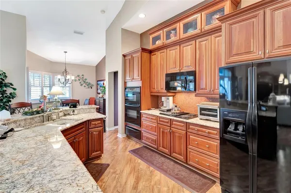 a kitchen with stainless steel appliances granite countertop a stove and cabinets