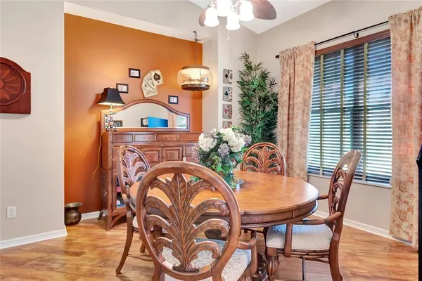 a view of a dining room with furniture and chandelier