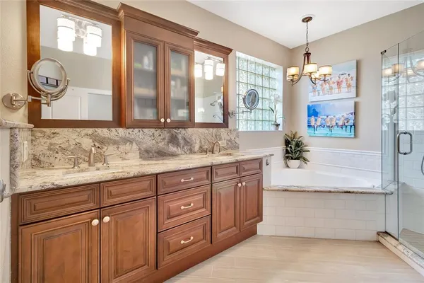 a bathroom with a granite countertop sink and a large mirror