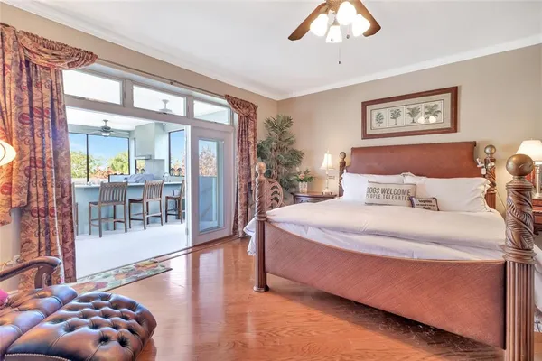 a bedroom with a large bed and a chandelier