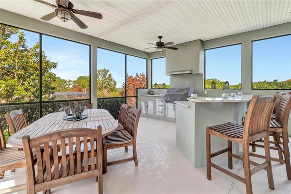 a living room with furniture a floor to ceiling window and furniture