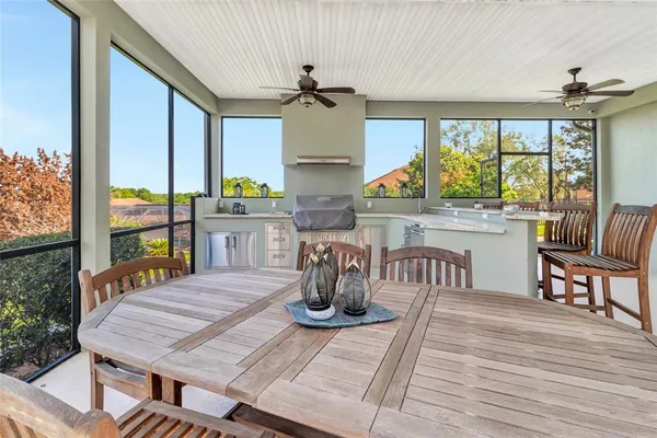 a kitchen with a table chairs and wooden floor