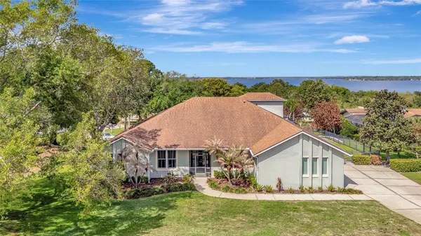 a house with green field in front of it
