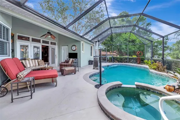 a view of a house with backyard and sitting area