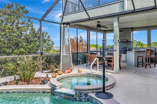 an aerial view of a house with outdoor space pool seating area and yard