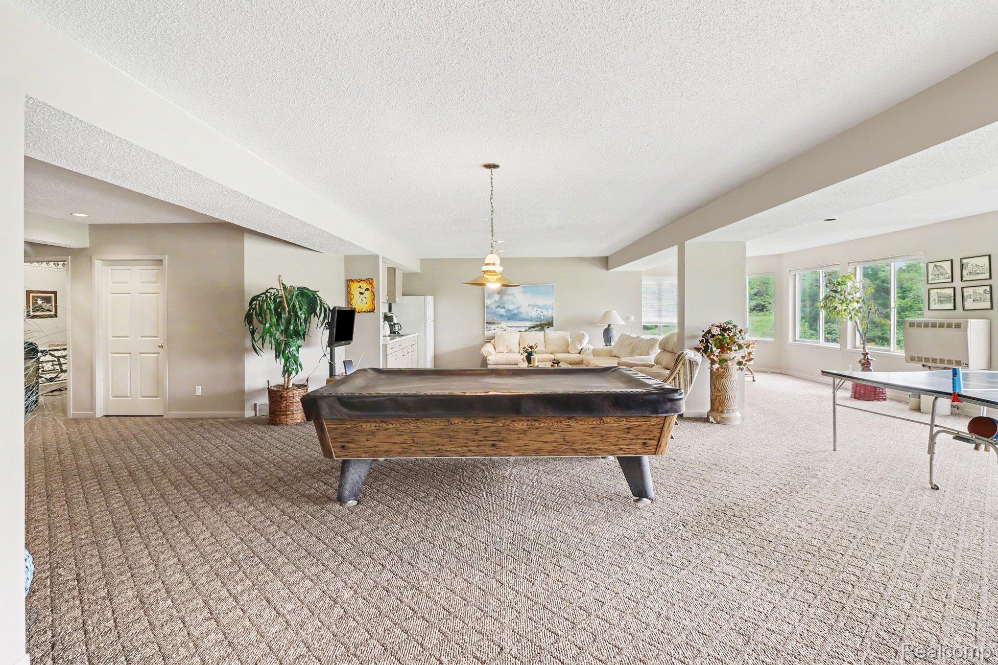 18501 Taylor Lake Road Holly, MI 48442 - Photo 29 of 35 Spacious room featuring berber carpet flooring, family room and recessed lighting