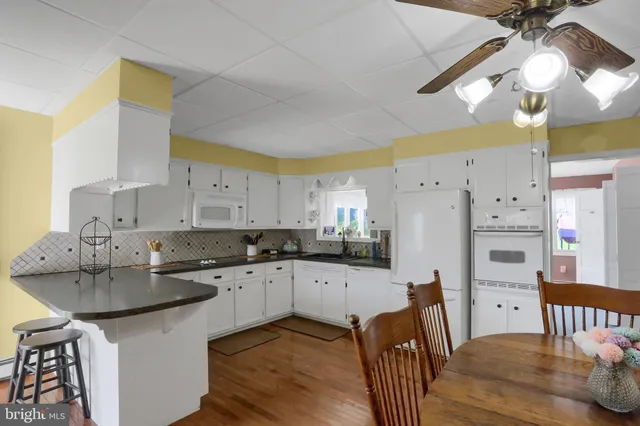 a kitchen with granite countertop a sink cabinets and refrigerator