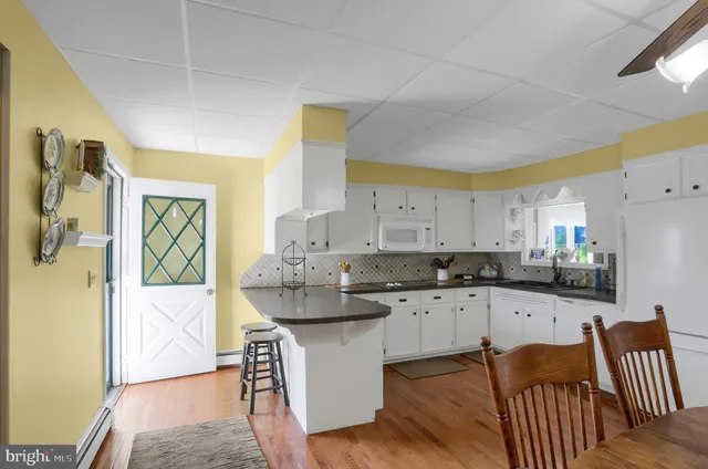 a kitchen with stainless steel appliances granite countertop a sink and a refrigerator