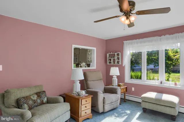 a bedroom with furniture and a large window