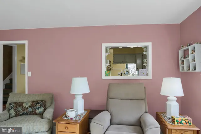 a living room with furniture and a lamp