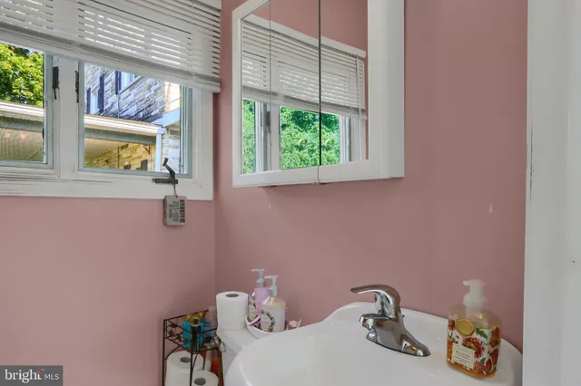a bathroom with a sink and a window