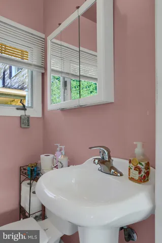 a bathroom with a sink and a window