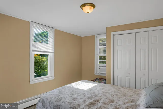 a view of a bedroom with closet and window