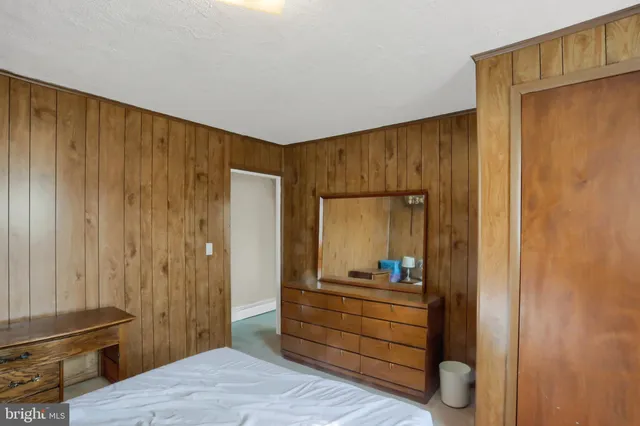 a room with a mirror and furniture