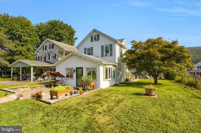 a view of a house with swimming pool and porch