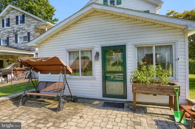 a view of a house with backyard and sitting area