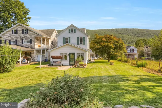 a front view of house with yard and swimming pool