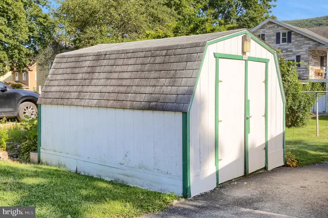 a view of a small house with potted plants
