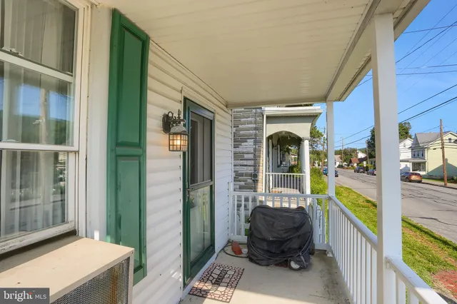 a view of a porch with furniture and front door