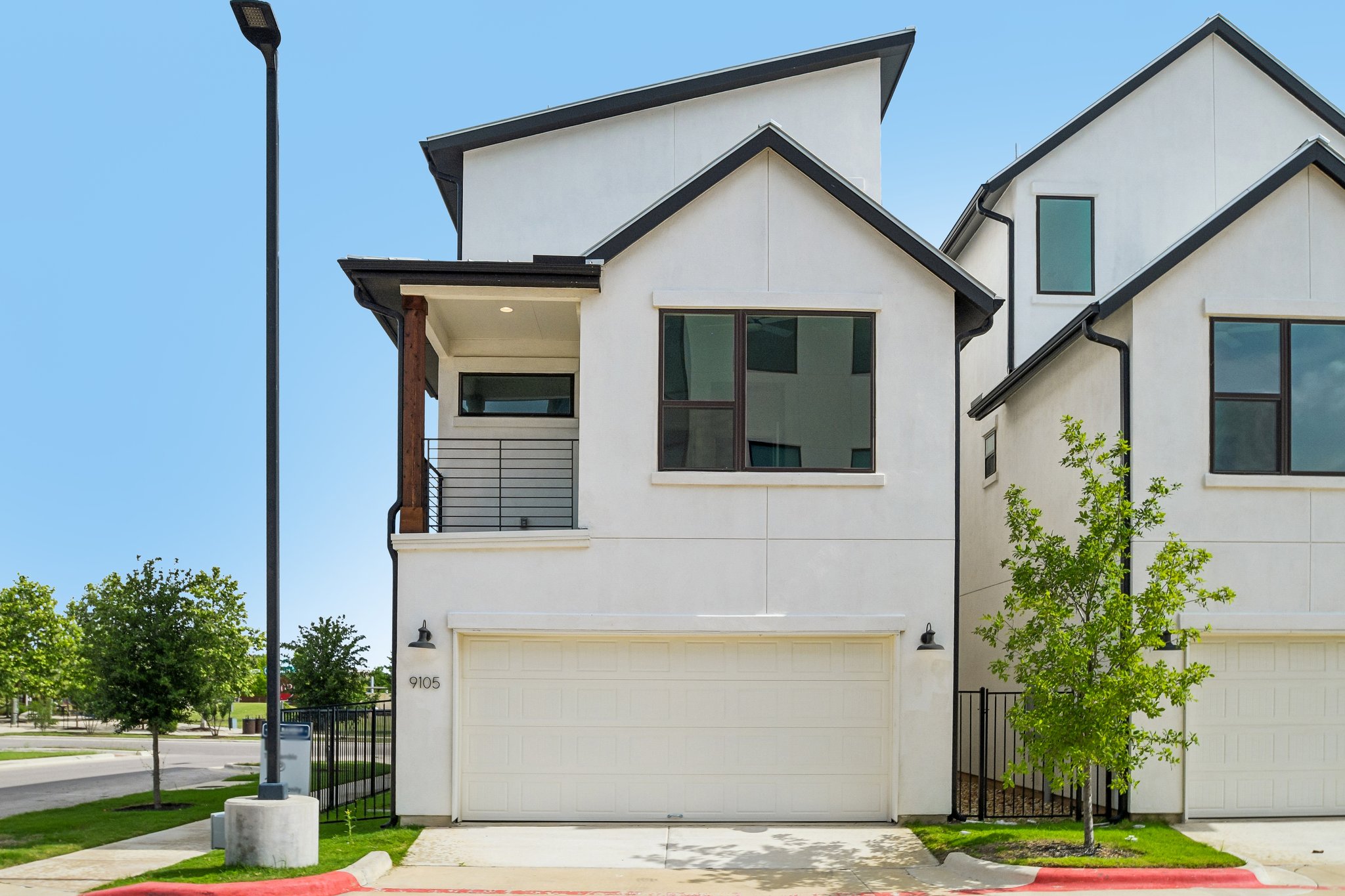 9105 Cattle Baron Path Austin, TX 78747 - Photo 29 of 31 Modern architecture defines this dwelling, with a private balcony extending from the upper level.