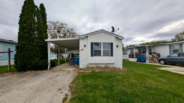 a front view of a house with a yard and porch