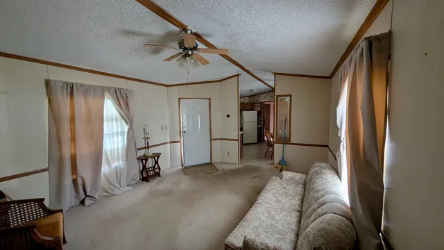 a view of a livingroom with furniture and staircase