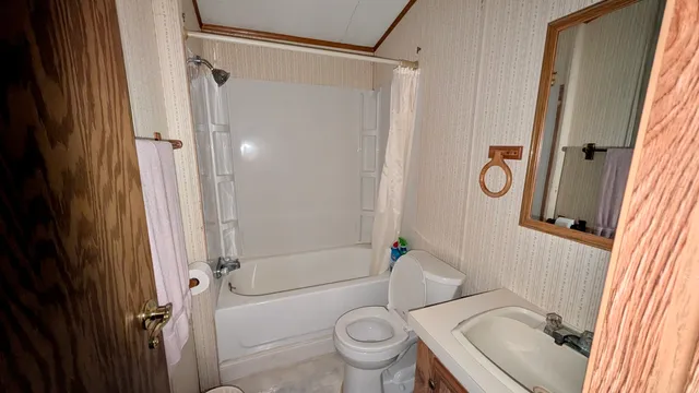 a bathroom with a granite countertop toilet sink and shower