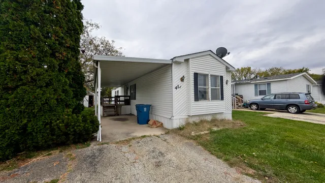a front view of a house with a garden and yard