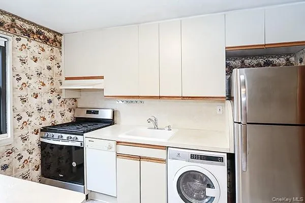 a kitchen with a refrigerator sink and stove