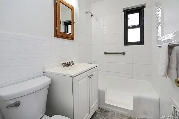 a bathroom with a sink a toilet and mirror