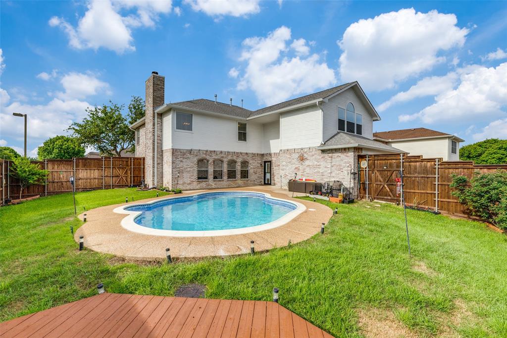 1445 Berkley Road Allen, TX 75002 - Photo 24 of 30 A large wooden deck behind the pool provides another option for outdoor seating or dining.