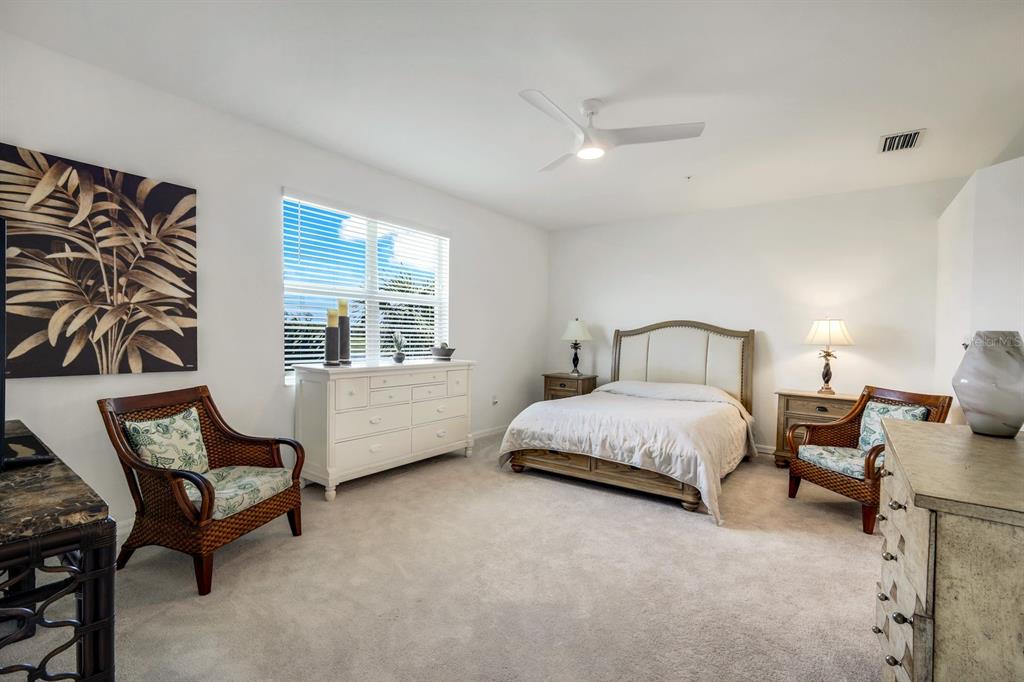 14180 Poppy Fld Loop Punta Gorda, FL 33955 - Photo 13 of 30 a spacious bedroom with a bed chair and window