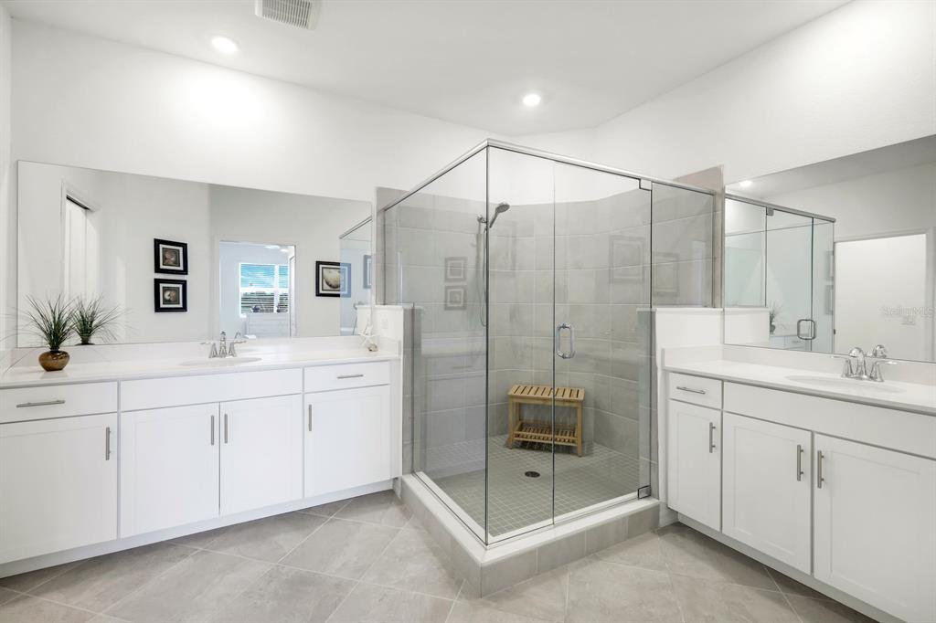 14180 Poppy Fld Loop Punta Gorda, FL 33955 - Photo 15 of 30 a spacious bathroom with a shower double sink and mirror