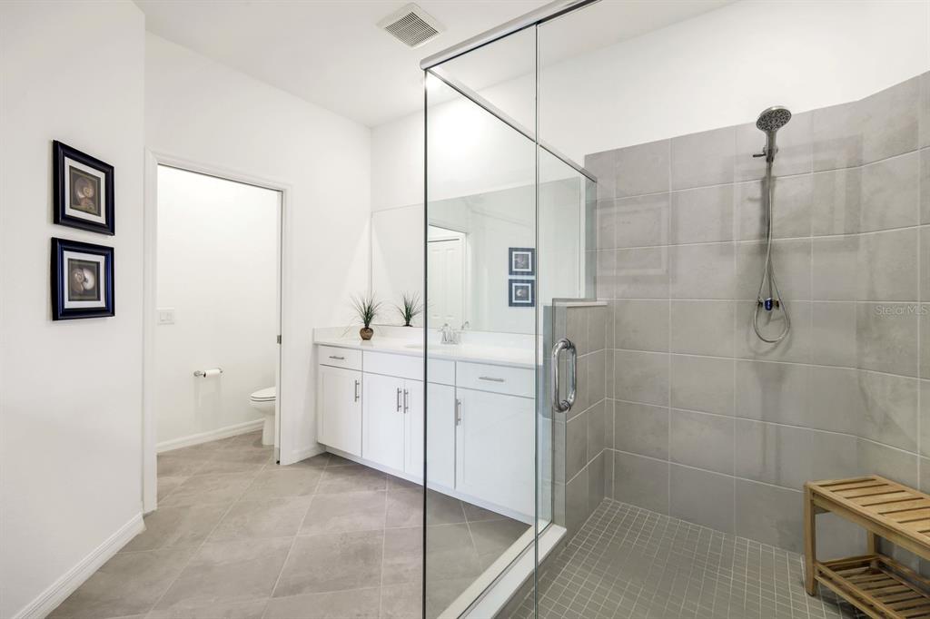 14180 Poppy Fld Loop Punta Gorda, FL 33955 - Photo 16 of 30 a spacious bathroom with a granite countertop sink a toilet and shower