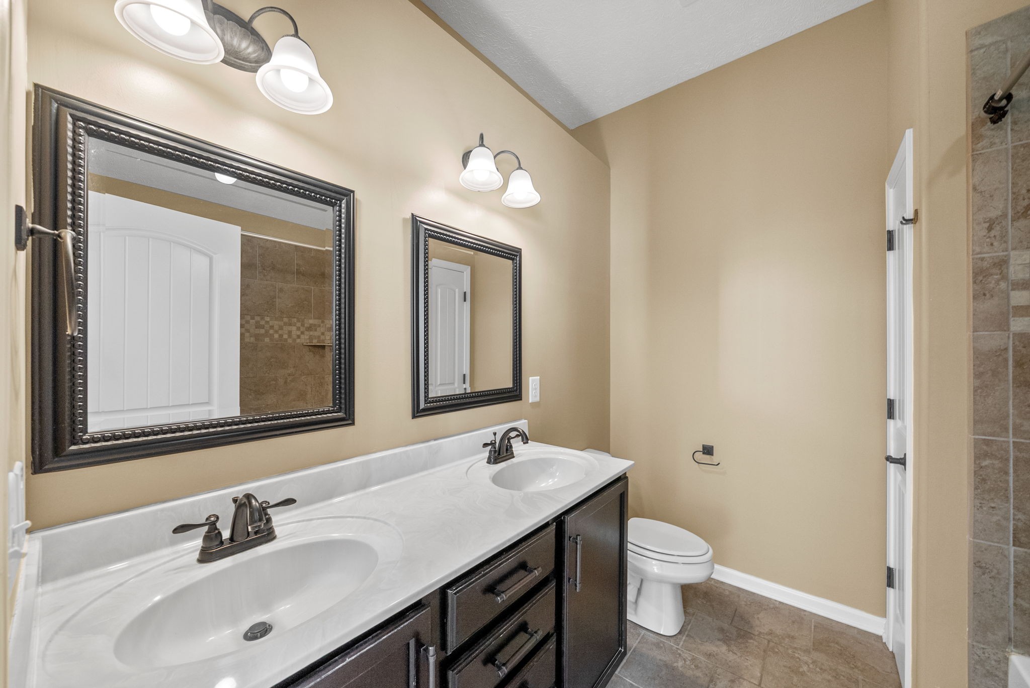 3783 Suiter Road Clarksville, TN 37040 - Photo 17 of 31 a bathroom with a toilet a sink and mirror