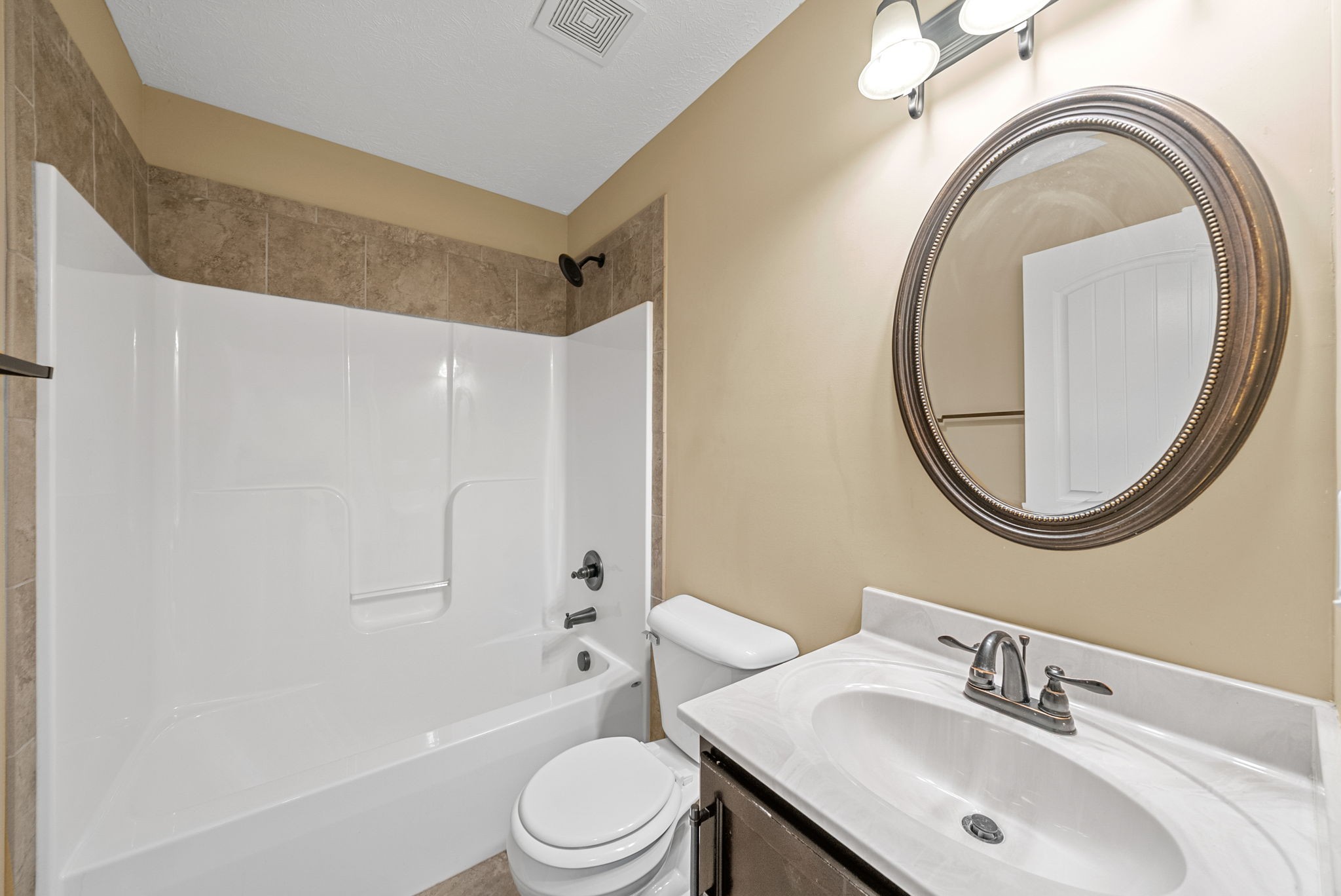 3783 Suiter Road Clarksville, TN 37040 - Photo 22 of 31 a bathroom with a toilet a sink a mirror and bathtub