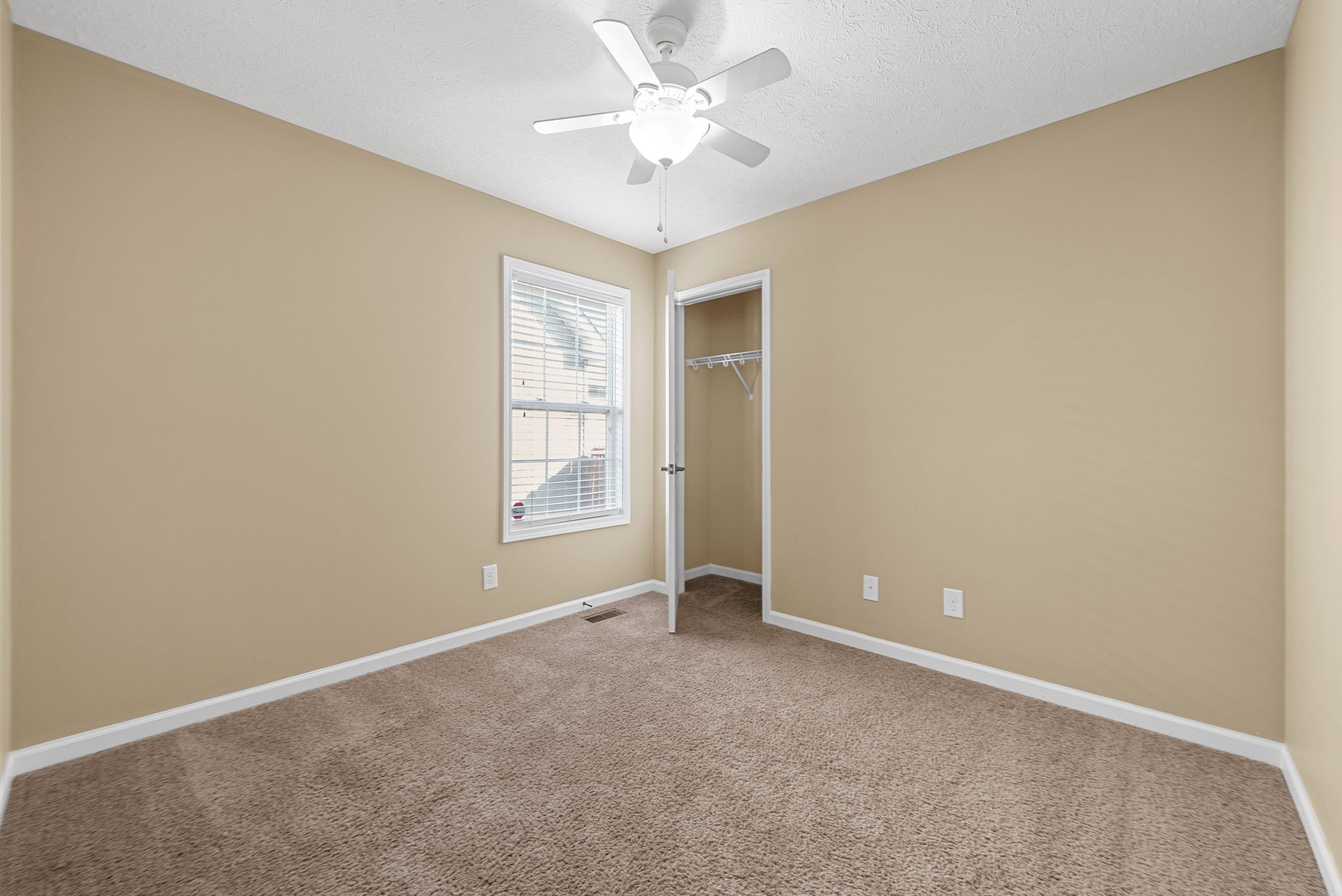 3783 Suiter Road Clarksville, TN 37040 - Photo 23 of 31 an empty room with windows and ceiling fan
