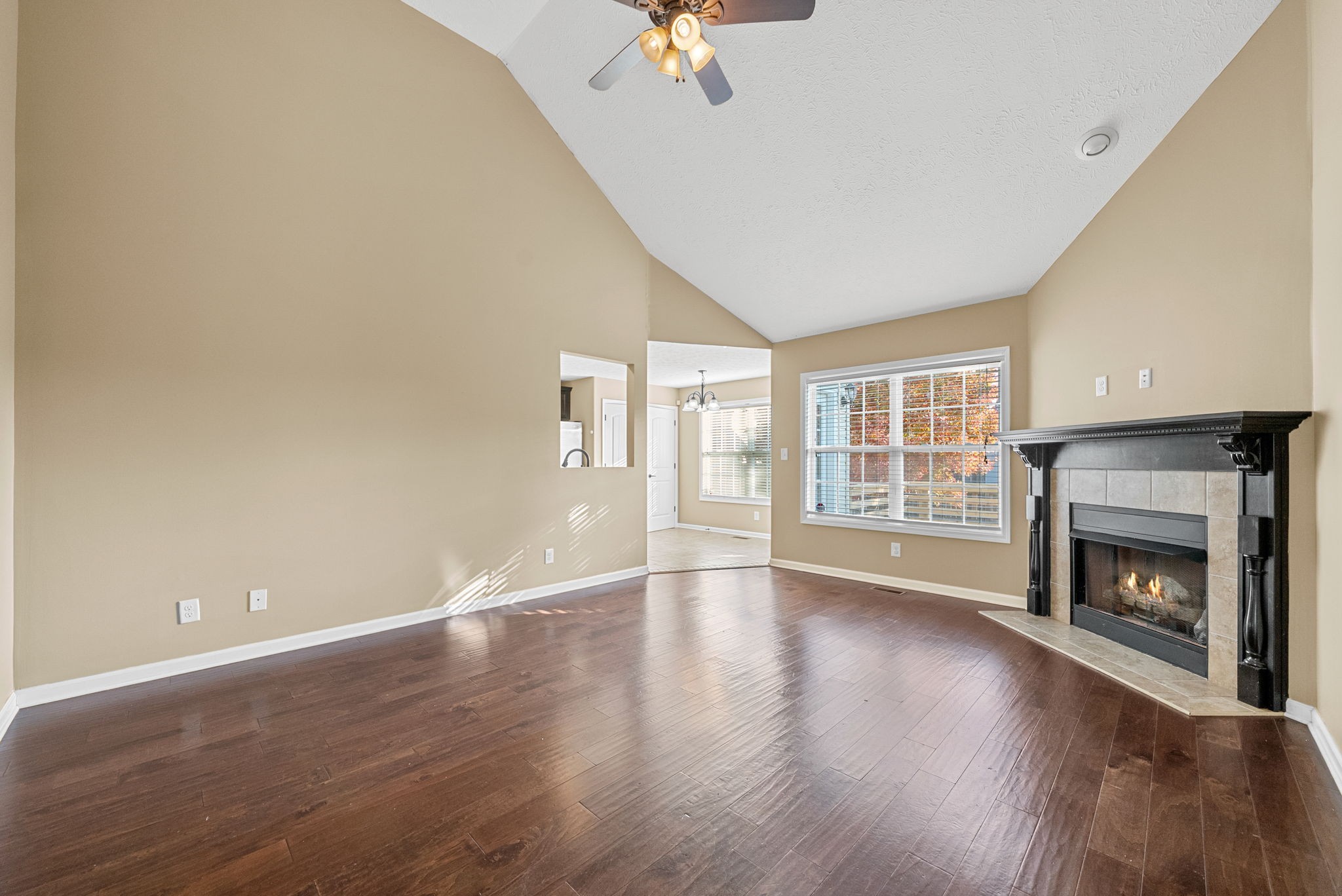 3783 Suiter Road Clarksville, TN 37040 - Photo 7 of 31 a view of an empty room with wooden floor fireplace and a window