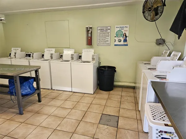 a kitchen with granite countertop a sink a stove and a microwave oven