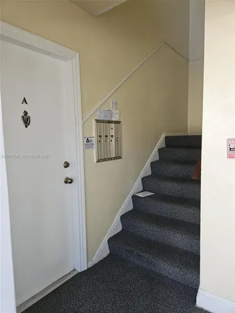 a view of staircase with white walls
