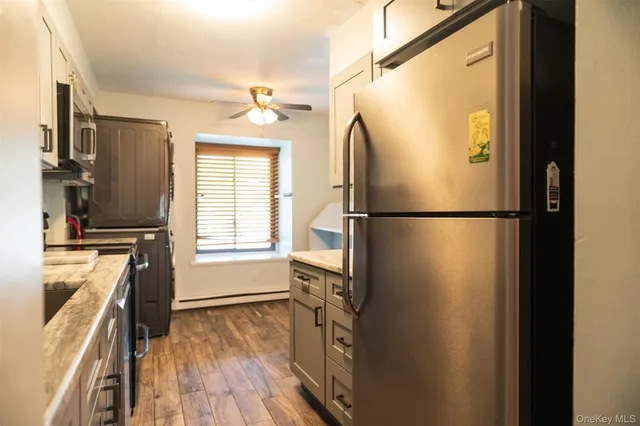 a kitchen with stainless steel appliances granite countertop a refrigerator and a stove