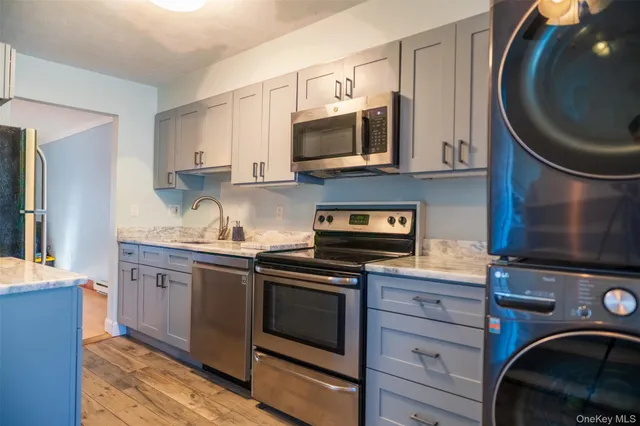 a kitchen with stainless steel appliances granite countertop a sink and a stove