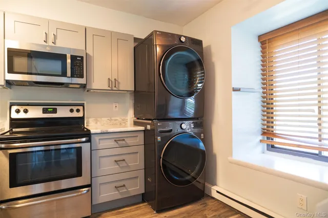 a kitchen with stainless steel appliances a stove a microwave and cabinets