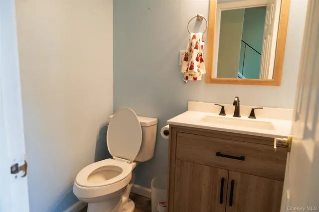 a bathroom with a toilet sink and mirror