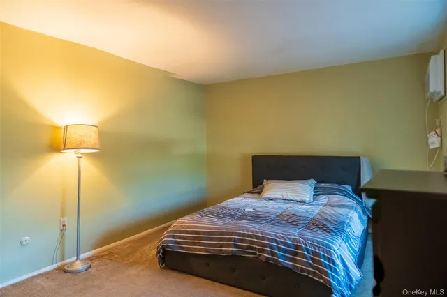 a bedroom with a bed and a lamp