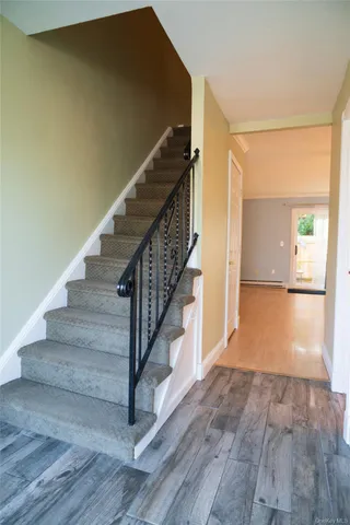 a view of entryway and hall with wooden floor
