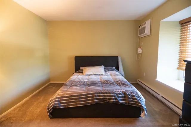 a bedroom with a bed and a mirror