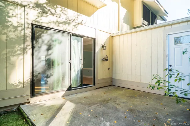 a view of a balcony with wooden floor and fence